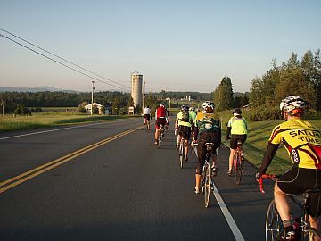 Line of riders passing farm